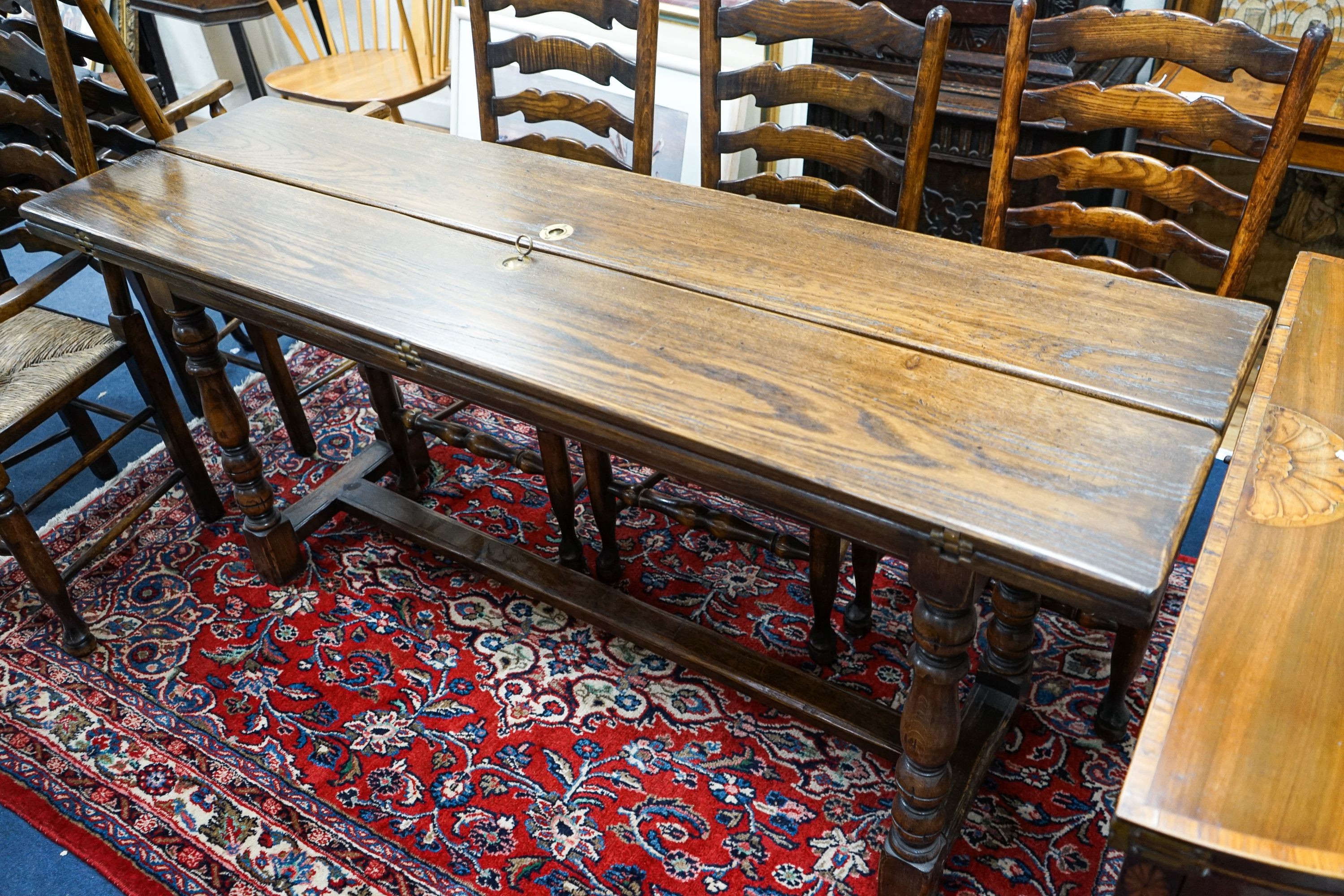 A Titchmarsh & Godwin 18th century style rectangular oak dining table with twin flap folding top, length 170cm extended, depth 99cm, height 74cm